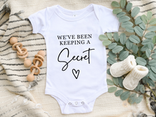 Load image into Gallery viewer, We've Been Keeping a Secret Onesie