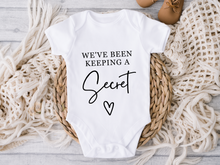 Load image into Gallery viewer, We've Been Keeping a Secret Onesie